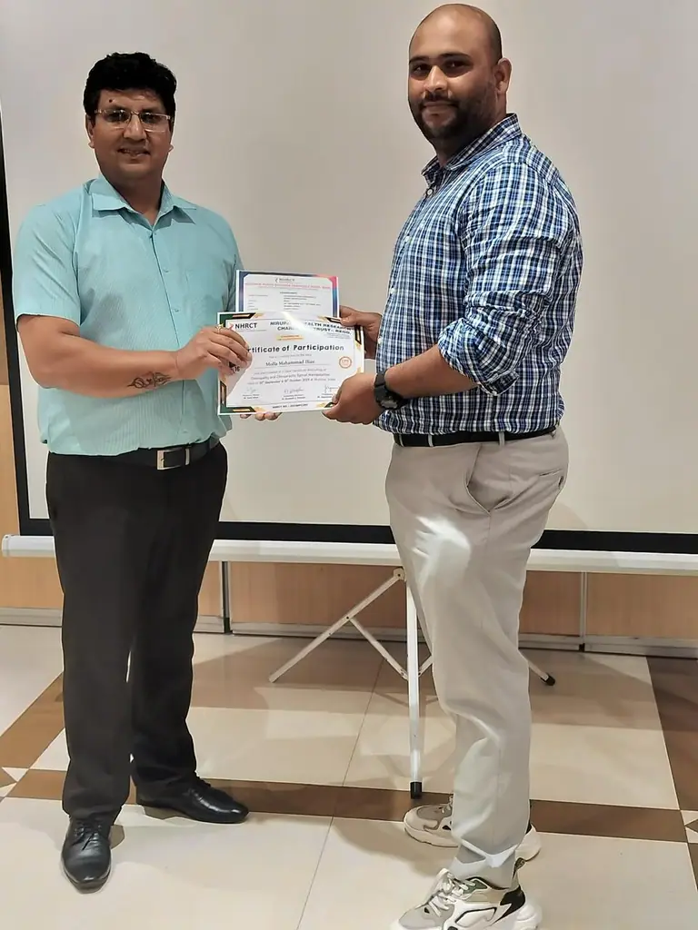 Dr. M Mahammad Ilias receiving a certificate for advanced spinal manipulation training